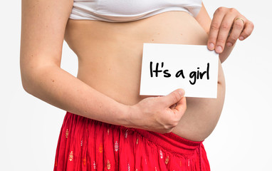 Pregnant woman with inscription: It's a girl