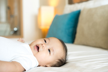Obraz na płótnie Canvas Portrait of a newborn Asian baby on the bed