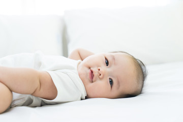Portrait of a newborn Asian baby on the bed © alice_photo