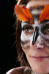 Girl in the mask of an owl, body art