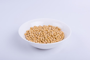 Soybeans in a white bowl isolated on white background.