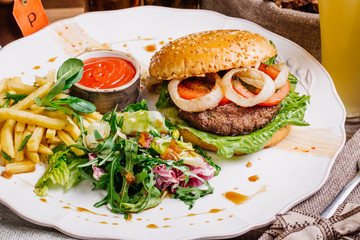 burger on sesame buns with succulent beef patties and fresh sala