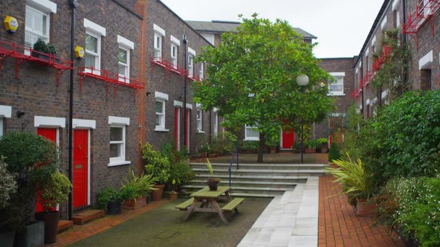  Exterior view of colourful London mews houses built around central courtyard