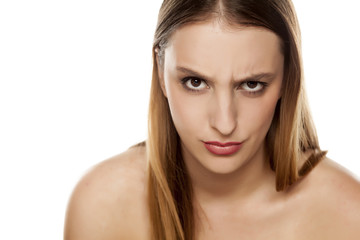 Fototapeta premium angry young woman with a raised eyebrow