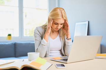 Worried woman, tired working with laptop at home office