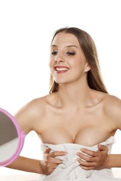 young woman looking and squeezing her breasts and cleavage in