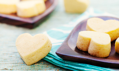 Handmade heart shape cookies on wooden plate