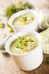 Zucchini soup with peas, decorated with egg