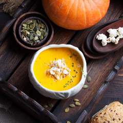 Pumpkin soup with salty popcorn in a ceramic bowl
