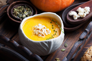 Pumpkin soup with salty popcorn in a ceramic bowl