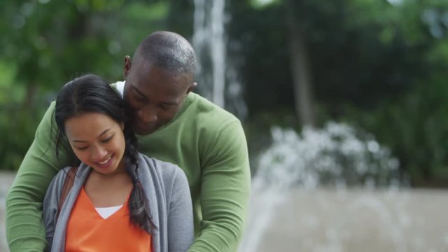  Portrait of happy couple expecting a baby, standing outdoors