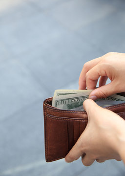 Hands Taking Out Money From Wallet On Street