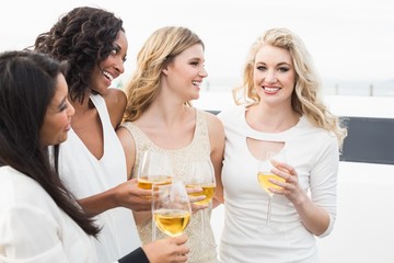 Well dressed men drinking wine next to a limousine