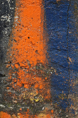 Obraz na płótnie Canvas Dirty concrete wall with orange and blue paint