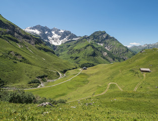 Obraz premium A view of Alpine mountains surrounding the village Schroecken in Bregenzerwald, region Vorarlberg, Austria