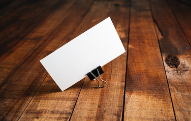 Blank business card. Photo of blank business card on vintage wooden background. Mock-up for...