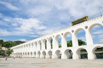Bonde de Santa Teresa tram train drives along distinctive white arches of the landmark Arcos da...