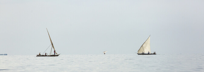 Fototapeta premium Traditional fisherman boat in Zanzibar on ocean with rainy cloud