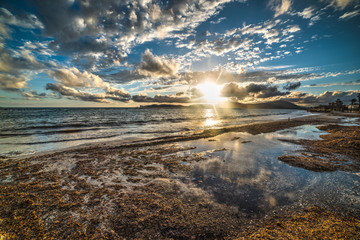 shining sun over Alghero at sunset