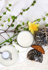 glass of milk and sweet cakes with ginger and vanilla rustic home cooking white background