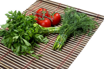 linking of parsley, fennel and branch tomato, on a rug