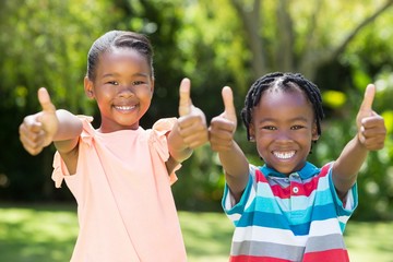 Young children doing thumbs up