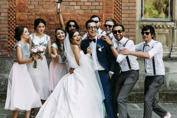 Crazy couple and bridesmaids with groomsmen behind