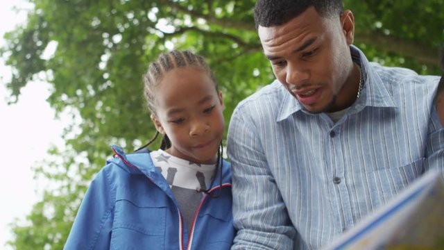  Happy Single Parent Family Sightseeing In London, Looking At Map For Directions. 