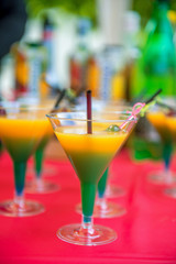 yellow green cocktail with cherry