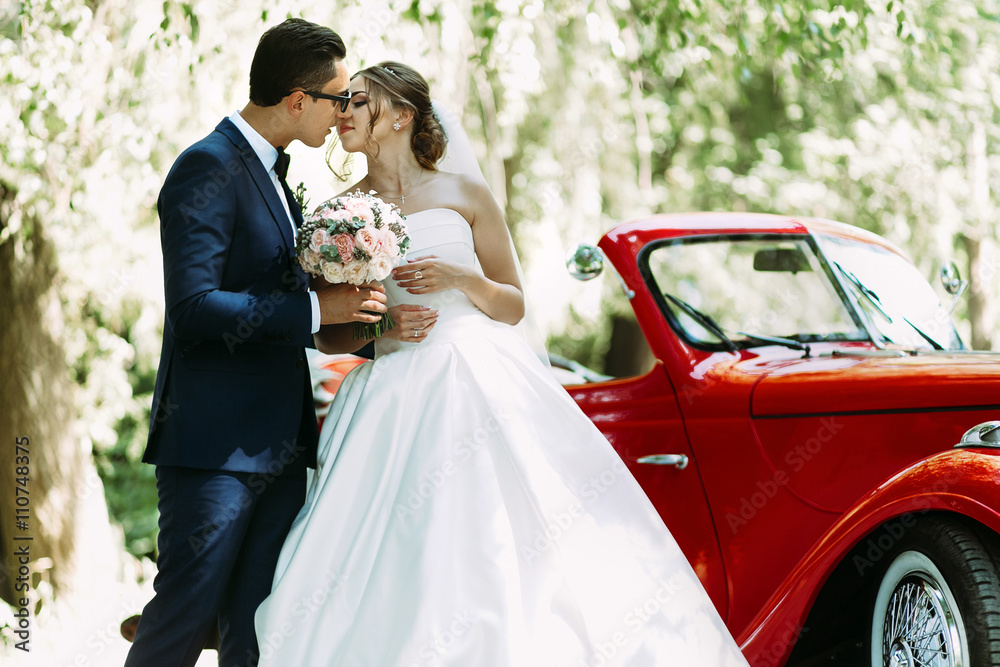 Wall mural Young just married couple in the sunny day