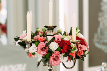 Colorful flowers and white candles