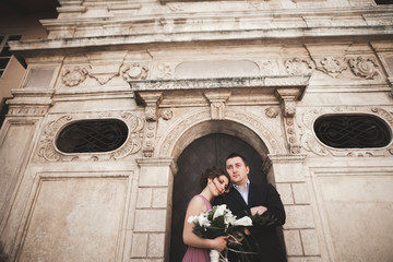 Fototapeta na wymiar Elegant beautiful wedding couple posing near a church. Krakow