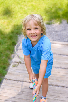 Happy  little boy climbing on outdoor playground