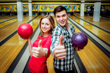 Beautiful girl and young man at the bowling alley