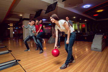 Cheerful friends at the bowling alley