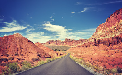 Vintage toned curved road, travel concept.