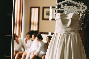 Fabulous bridal dress on a hanger in the hotel