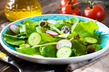 Fresh green salad on wooden background