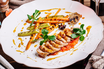 Roasted duck with pear,marinated in red wine on a wood table background in the restaurant