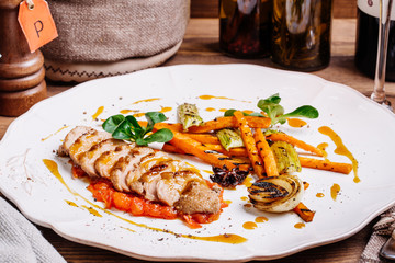 Roasted duck with pear,marinated in red wine on a wood table background in the restaurant