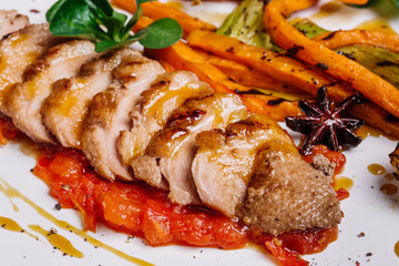 Roasted duck with pear,marinated in red wine on a wood table background in the restaurant