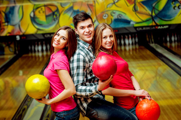 Fototapeta na wymiar Cheerful friends at the bowling alley