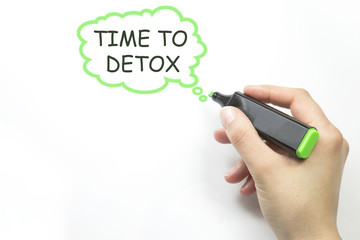 Women Hand writing time to detox with marker.