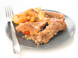 homemade stew pork ribs and potatoes with peppers on dish