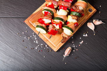 Preparing food for cooking barbecue on skewers on black stone