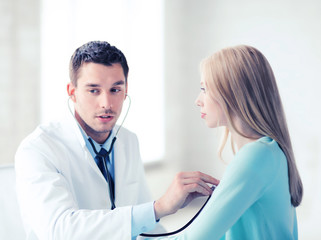 doctor with stethoscope listening to the patient