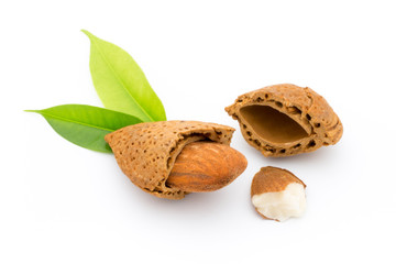 Almonds with leaves isolated on white background