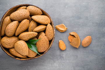 Group of almond nuts with leaves.Wooden background.