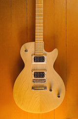 Electric vintage guitar on wooden background