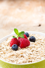Oatmeal porridge with berries. Raspberries and blueberries.